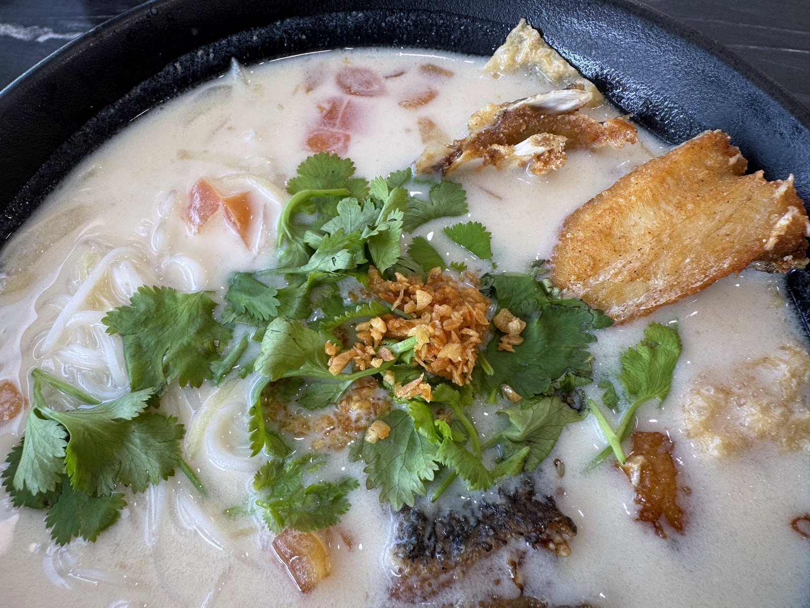 Milky fish head noodle soup